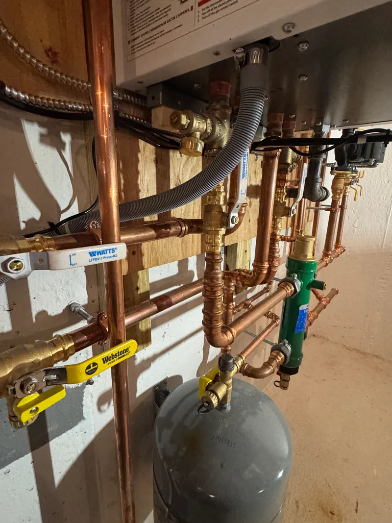 Hydronic boiler piping and expansion tank in a mechanical room