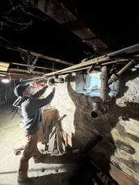 Active drain and waste piping repair in a stone foundation basement
