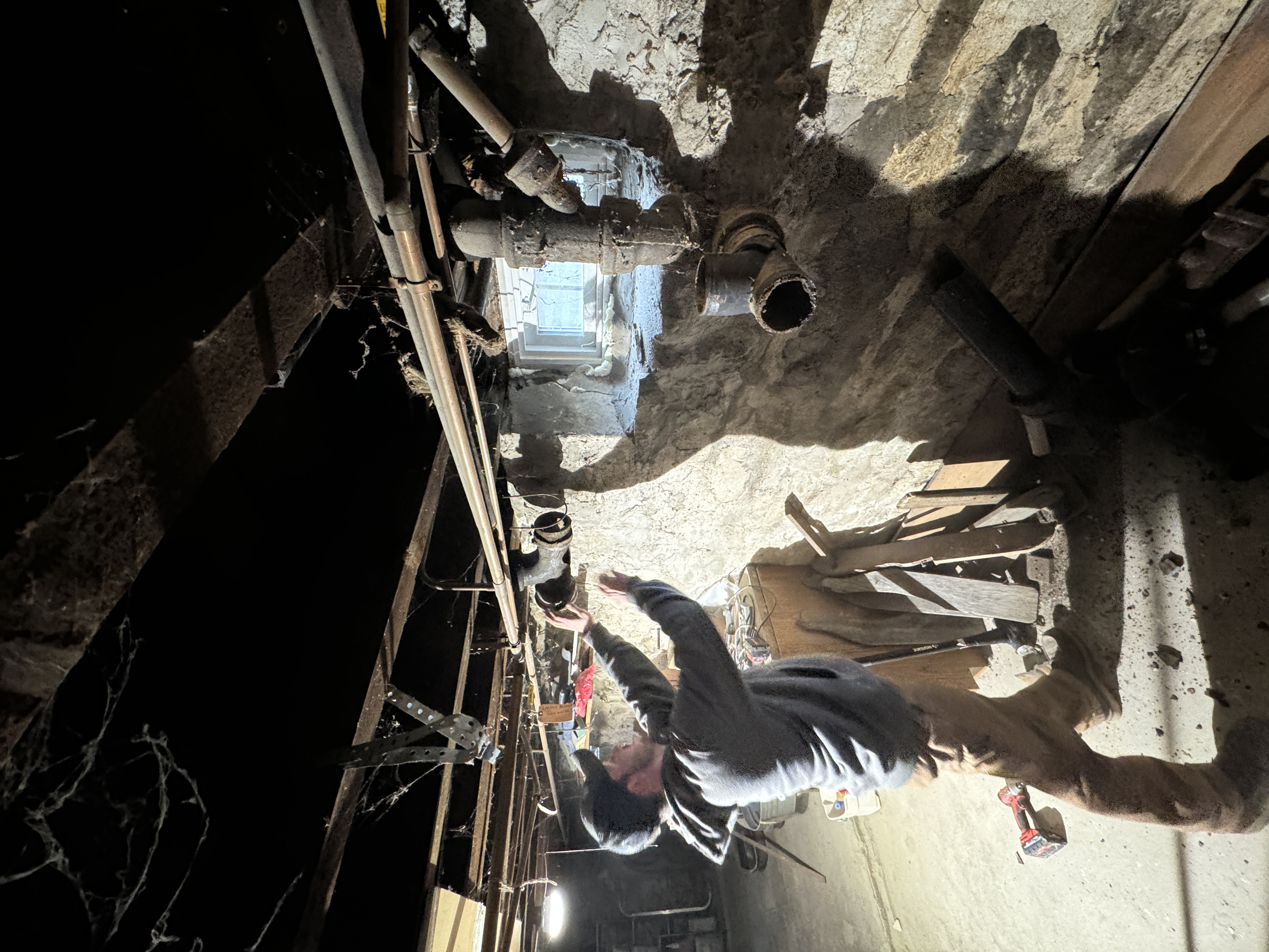 Active drain and waste piping repair in a stone foundation basement